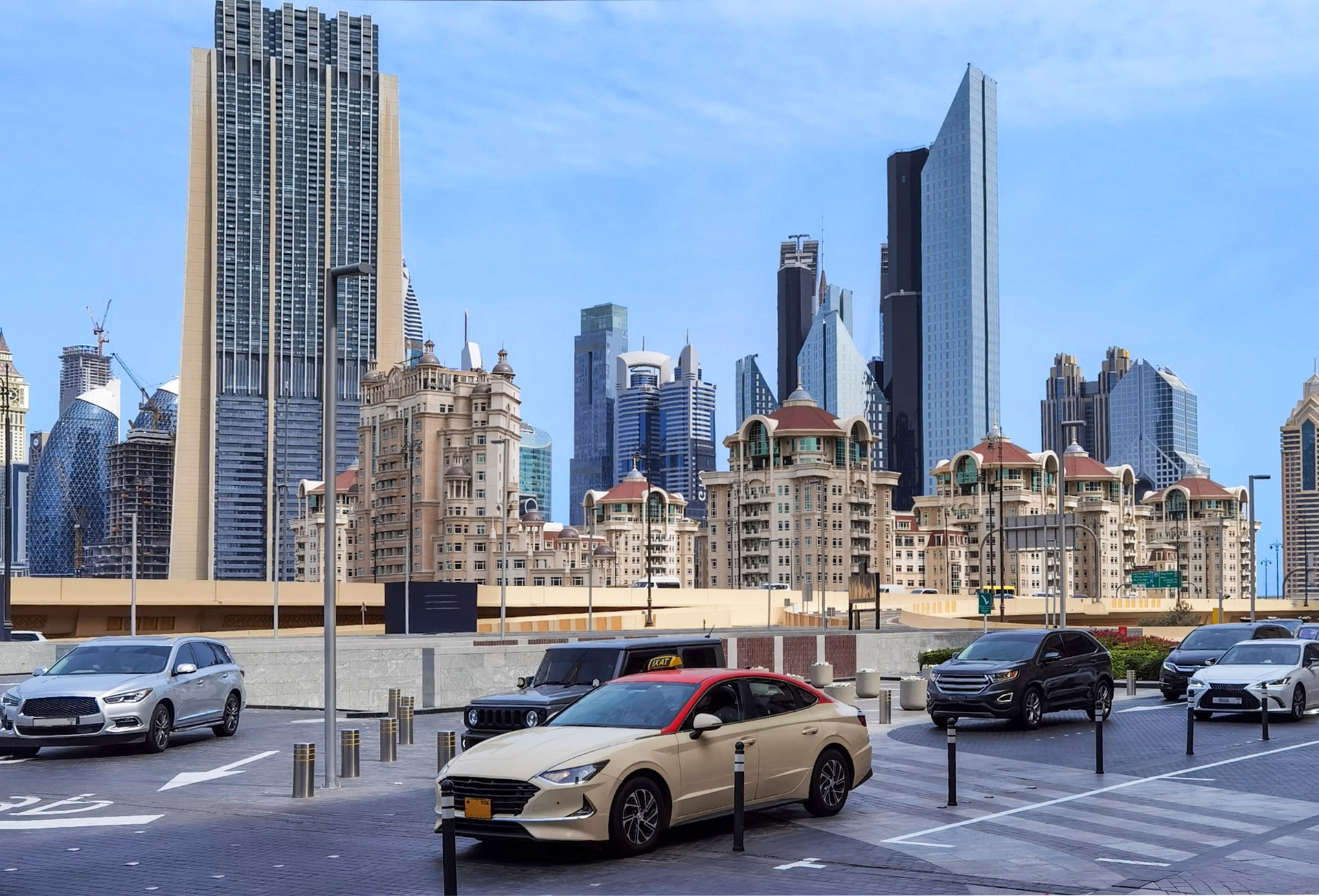Dubai urban scene with luxury cars and a mix of modern skyscrapers and traditional buildings.