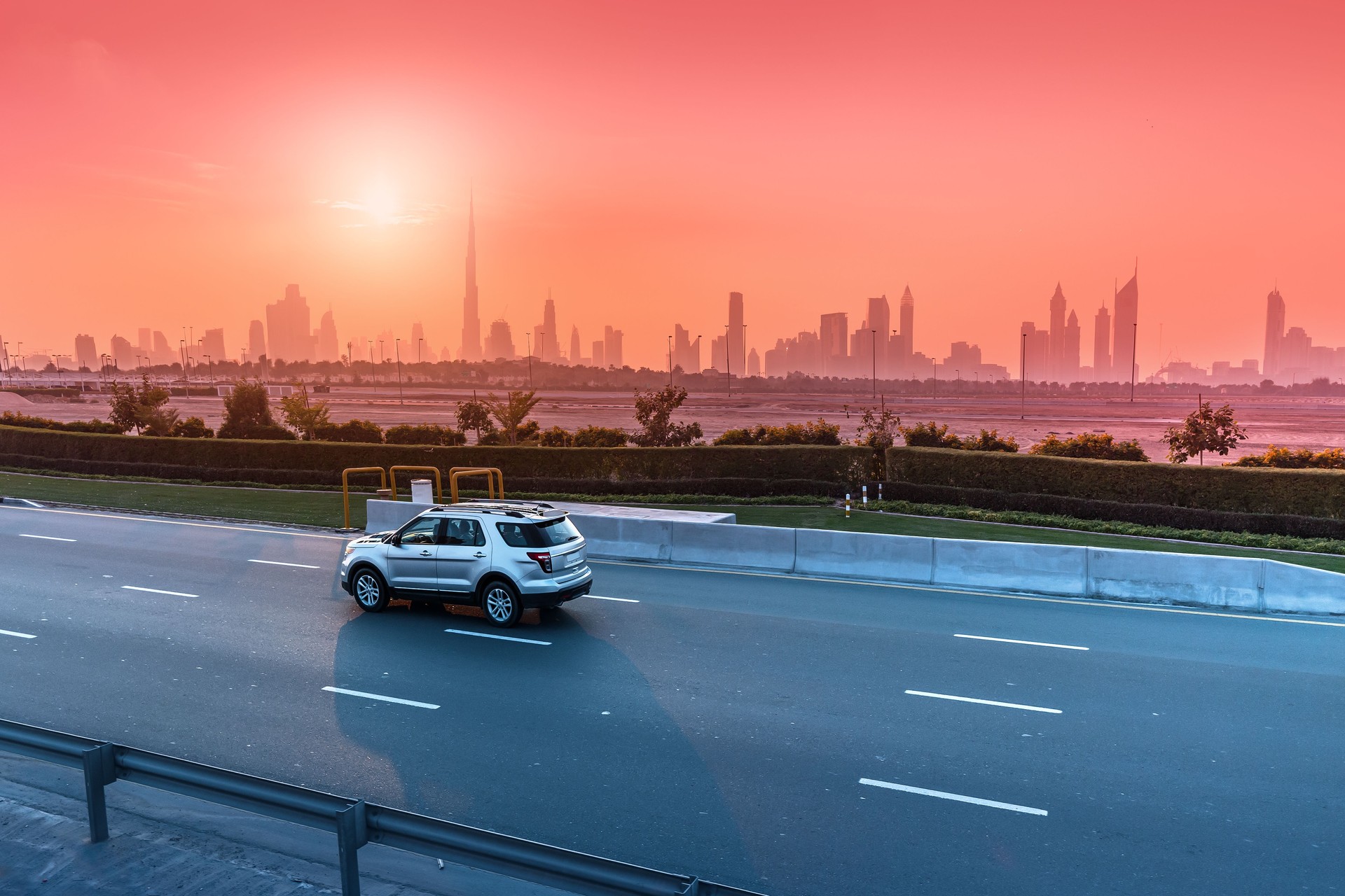 Highway Road and Dubai cityscape skyline at sunset. Transportation and travel in UAE concept
